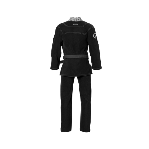 Breathable black gi shown in academy setting with reinforced seams and white belt