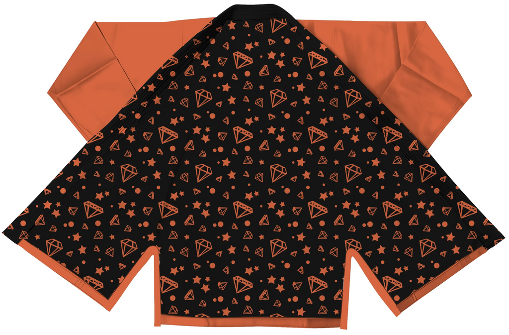 Orange gi for kids displayed with pearl weave jacket and ripstop pants